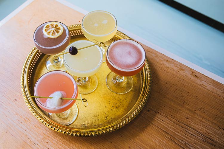 Tasty Summer cocktail drinks on a golden tray