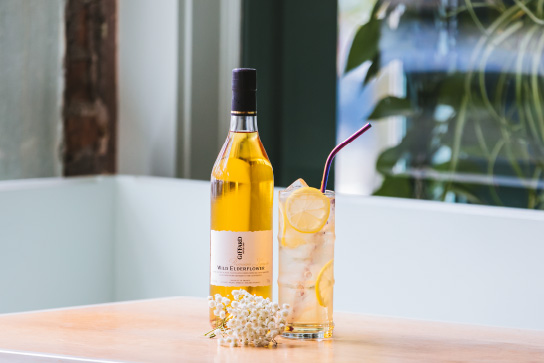 Giffard Wild Elderflower liqueur bottle with cocktail
